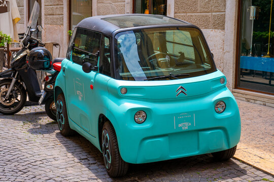 Cyan Citroen Ami Electric Car on Cobblestone Italian old street. Verona, Italy - June 25, 2026