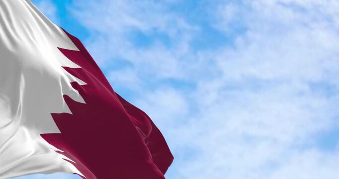 Qatar national flag waving in the wind on a clear day