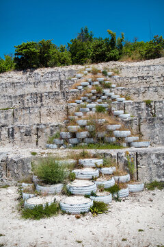 A section of a limestone mountain in steps after mining a deposit on a clear sunny day. Mining technology and hydrology.