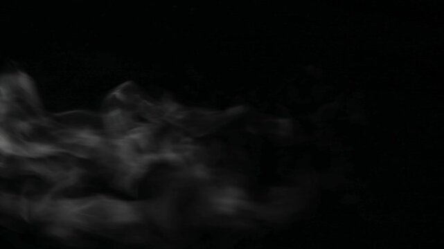 White steam drifting horizontally left to right on black background, vertical mobile format