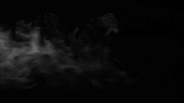 White steam drifting horizontally left to right on black background, vertical mobile format