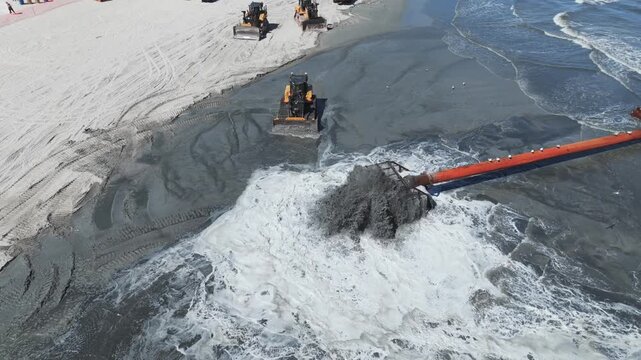 Aerial view of beach replenishment pipe pumping sand in Ocean City NJ