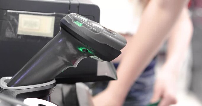scanning a notebook's barcode at the self-checkout. Education, back to school