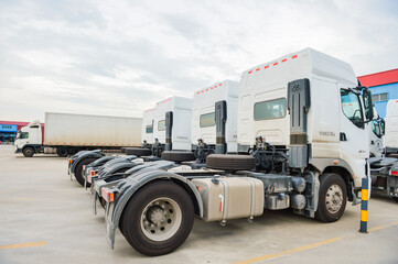 Obraz premium White semi truck fleet parked at logistics yard