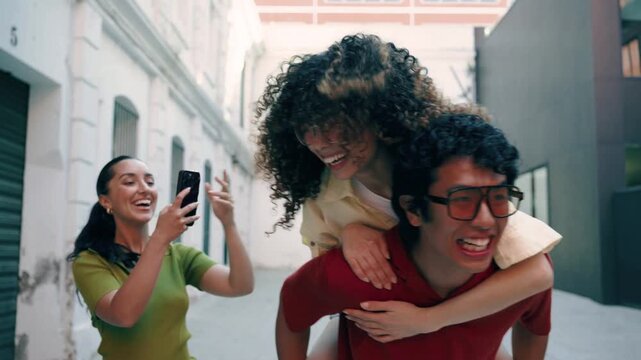 Video of three friends having fun while walking on the street