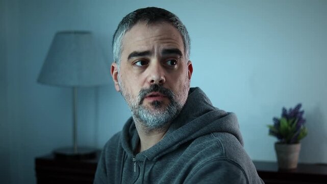 Portrait of a sad young man, close up, sitting down