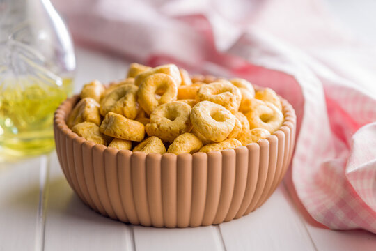 Italian Taralli Snack Rings In Ceramic Bowl With Olive Oil And Pink Checkered Cloth