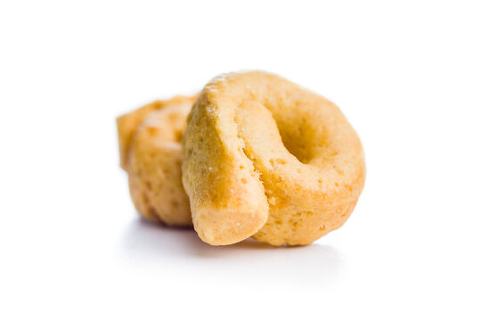 Pile of Golden Italian Taralli Snack Crackers on White Background Close-Up Food Still Life