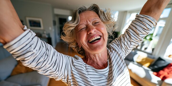 Older Woman Celebrating with Arms Raised