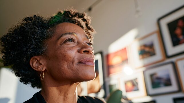 Older African-American Woman with Short Hair, Smiling and Looking Upwards, Indoors.