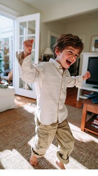 Young Boy Excitedly Running Through Living Room