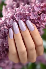 Fototapeta premium Woman Hand with Beautiful Pastel Lilac Manicure Holding Fresh Blooming Spring Lilac Flower Scents