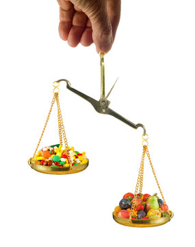 Balancing two bowls of candy using a scale held by a hand