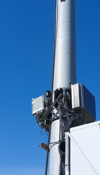 Small cell wireless installation, blue sky on background. Cellular base station for 5G and high-capacity 4G LTE networks. Equipment for transmitting and receiving signals, connection