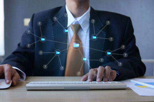Businessman Efficiently Operating Computer At Desk To Manage Company Data