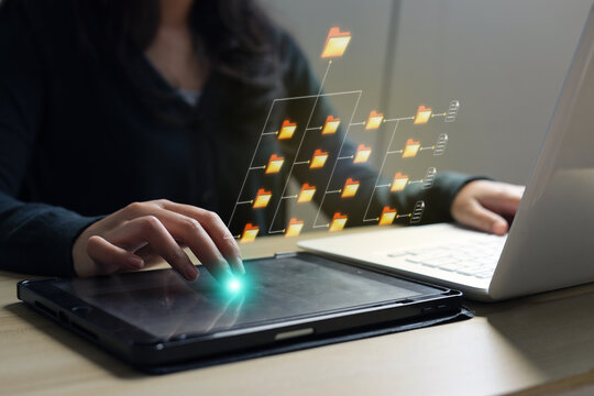 Woman Organizing Data Folders Inside Workspace Using Digital Tablet