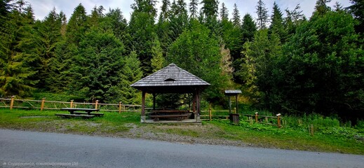A gazebo on a forest path and a picnic spot.