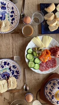 Breakfest table with bread, cheese, olives and coffee