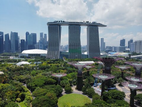 Aerial view of Marina Bay Sands hotel complex and the Supertree Grove at Gardens by the Bay with the city skyline in the background in Singapore, Singapore, Singapore.