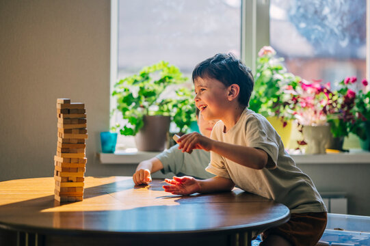 Family playing wooden block educational game together indoors