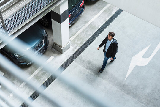 Businessman walking in parking garage