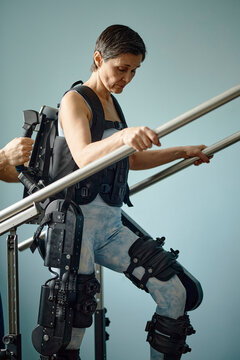 Woman uses an exoskeleton for rehabilitation in a clinic