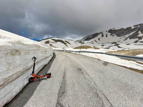 Electric scooter on a snowy mountain road in Gran Sasso Italy
