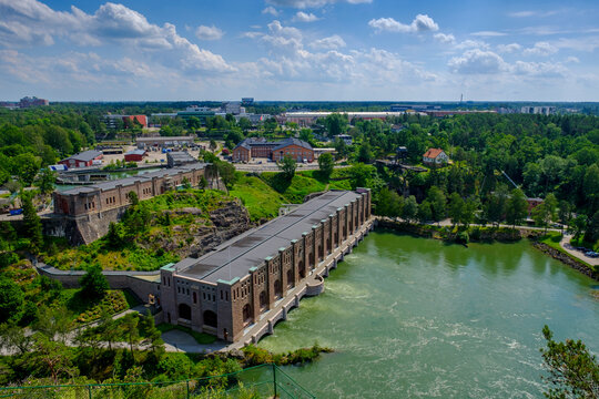 Sweden, Vastra Gotaland County, Uddevalla, Hydroelectric power station on Gota Alv river with town in background