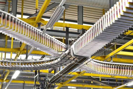Conveyor belts with newspapers in a printing shop