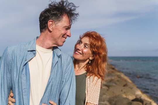 Senior couple shares a happy smile on the beach