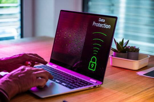 Man types on notebook showing data protection in the office