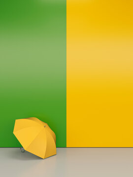 A yellow umbrella stands against a green and yellow wall