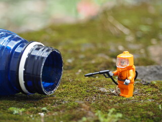 Fototapeta premium Indonesia - April 14, 2022 : Mini toy of action figure at table with blurred. Toy photography concept. Hazmat suit at outdoor conceptual design.