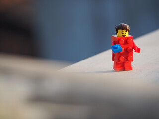 Fototapeta premium Indonesia - April 5, 2024 : Mini toy of action figure at table with blurred background. Toy photography concept. Construction conceptual design.