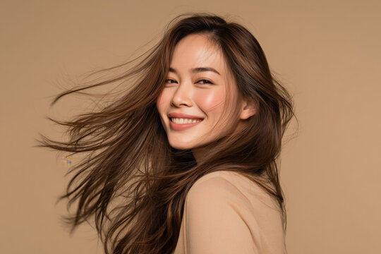 Smiling woman captured in natural motion as she turns her head to the right, with her hair flowing naturally.