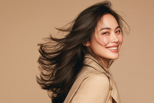 Smiling woman captured in natural motion as she turns her head to the right, with her hair flowing naturally.