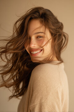 Smiling woman captured in natural motion as she turns her head to the right, with her hair flowing naturally.