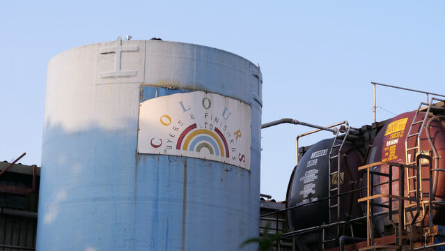 Leicester, England, UK - 9 July 2026: Colours Dyers & Finishers LTD. Industrial storage tank, liquid silo, chemical plant facility, outdoor steel reservoir with pipes
