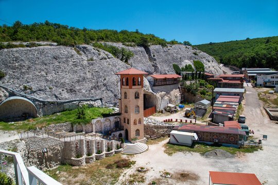 View of the Monastery of St. Anastasia the Great Martyr against the background of mountains on a clear sunny day. Nature, landscape, World tourism.