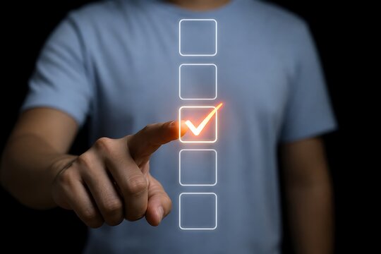 Hand pointing at glowing checkmark on digital interface, success concept