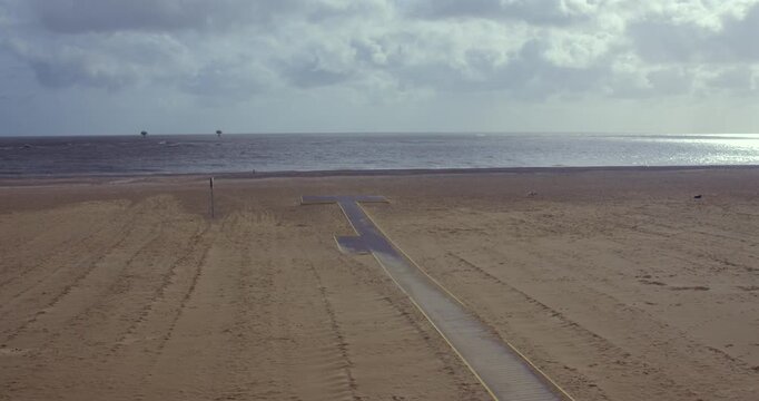Extra wide shot looking up across South beach with dogs