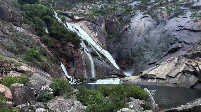 Impressive &Eacute;zaro waterfall cascading down granite cliffs in A Coru&ntilde;a Galicia Spain