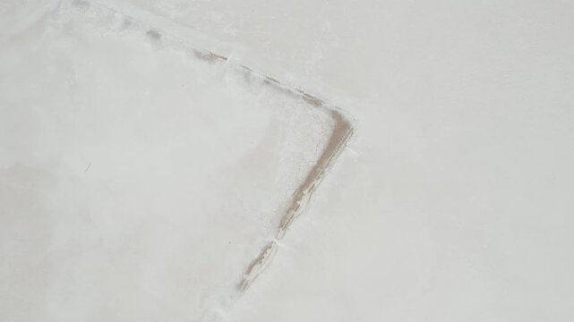 Rust Colored Sediment Streaks Marking White Salt Crust of Dry Lake Bed in South Australia, Top-Down Aerial Drone Shot