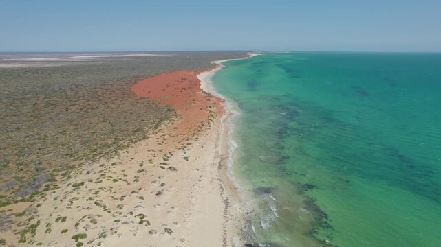 Red Sand Dunes Meeting Turquoise Ocean along Remote Coastline of Shark Bay Western Australia, Aerial Drone Shot