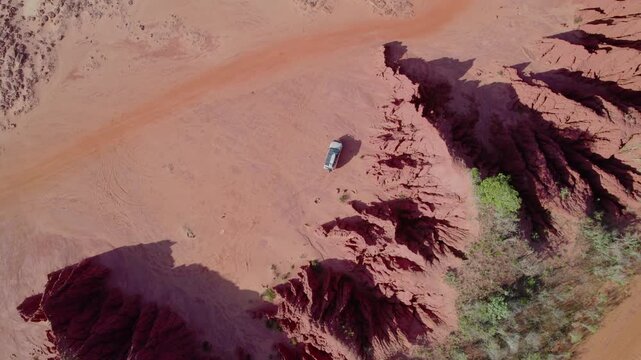 4WD Camped beside Eroded Red Cliff Formations at James Price Point Western Australia, Top-Down Aerial Drone Shot