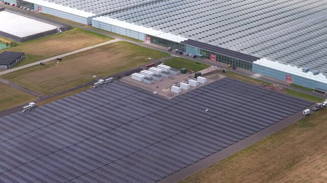 Aerial footage of a modern hyperscale data center in the netherlands, featuring extensive solar panels for renewable energy production