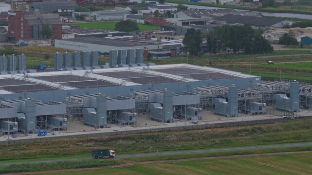 Aerial view of a modern hyperscale data center facility featuring advanced infrastructure, cooling systems, and renewable energy sources