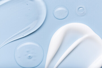 Fototapeta na wymiar samples of cosmetic care products smear of cream and gel texture on a light blue background