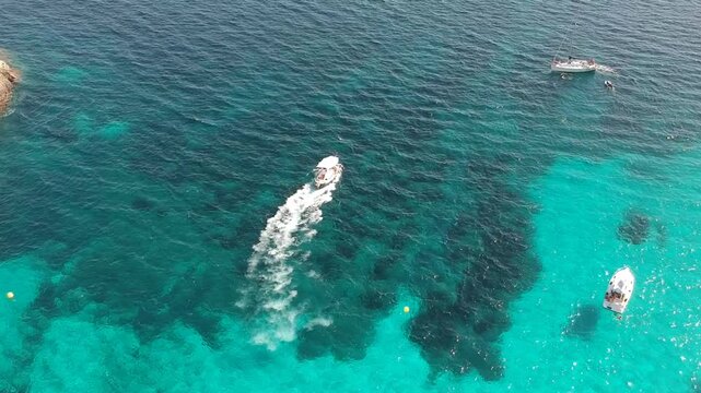 Boat in Crystal Clear Turquoise Water Seen from Above Overhead Drone Shot Cala Mitjana Menorca Spain