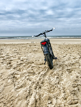 Electric fat bike gliding on soft sand, exploring the beach and coastline in a unique way